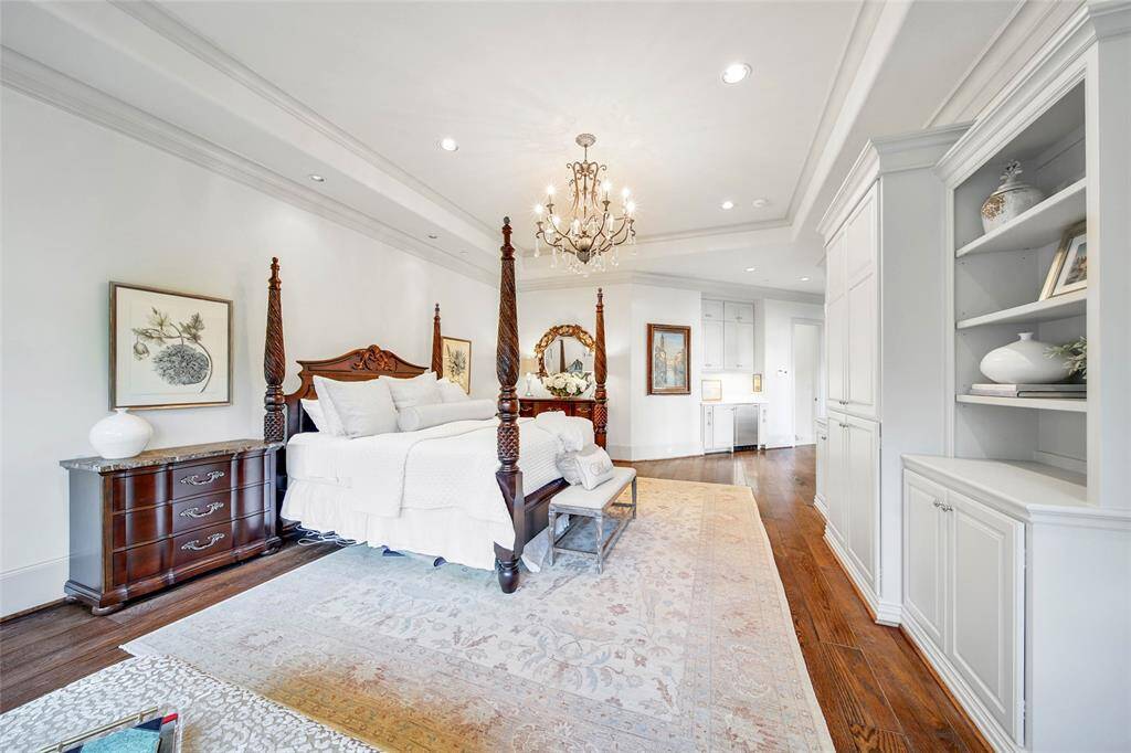 Vast primary suite featuring built-in shelves and a stunning ensuite bathroom.