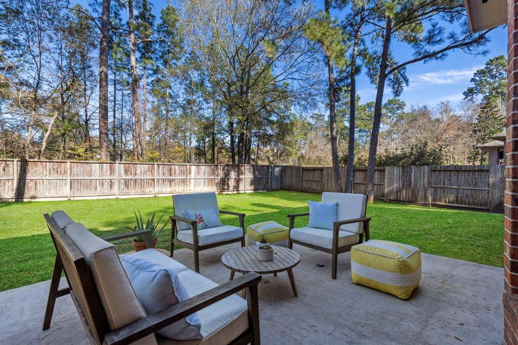 This inviting patio offers ample seating and a lush lawn, perfect for entertaining.