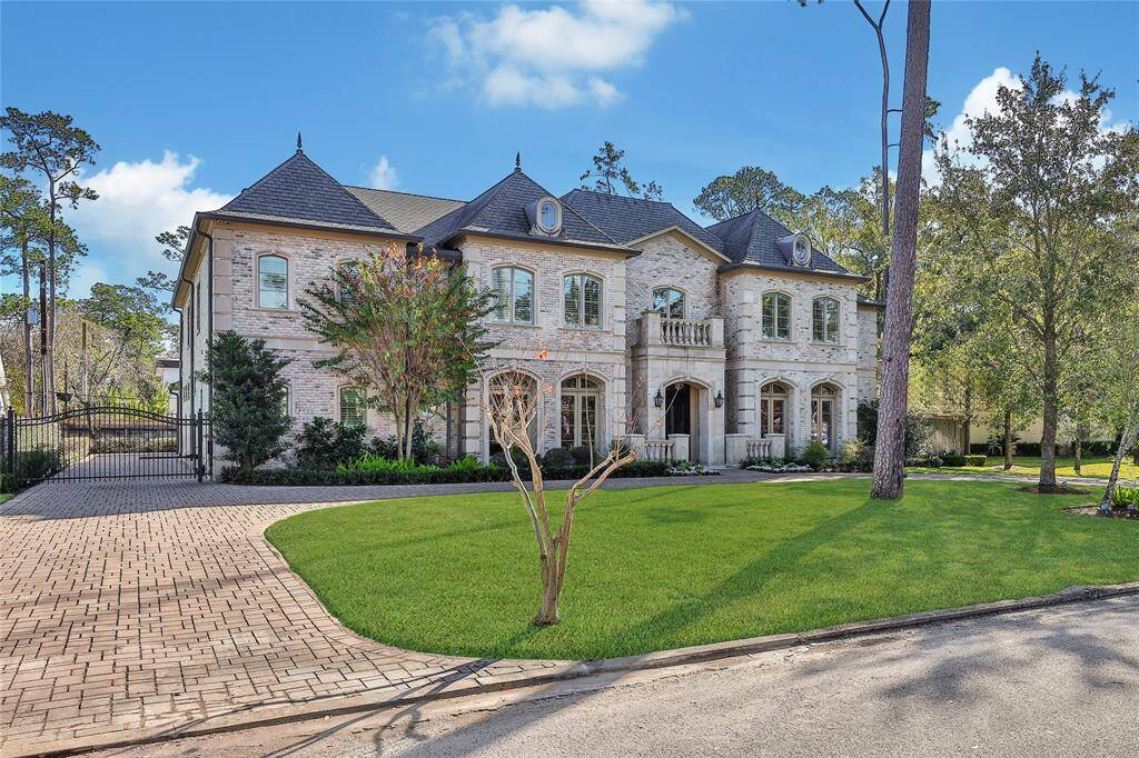 Beautiful curb appeal with circle driveway and gated private drive.