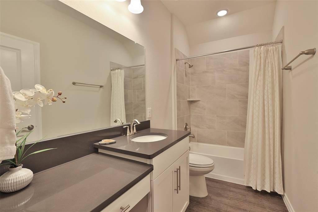Secondary full bath with plenty of counter and vanity space.