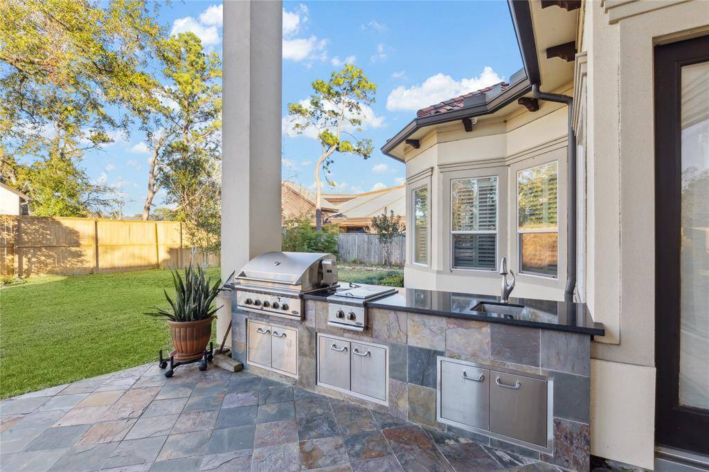 Summer kitchen complete with grill, sink and burner.
