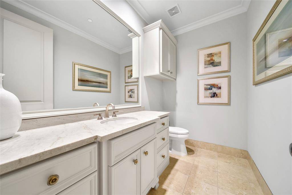 Upstairs half bathroom located off the game room.