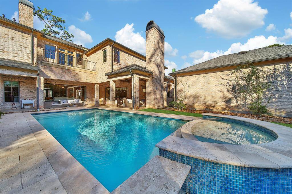 Stunning backyard featuring a pool and spa, a covered patio, and a fully-equipped outdoor kitchen.
