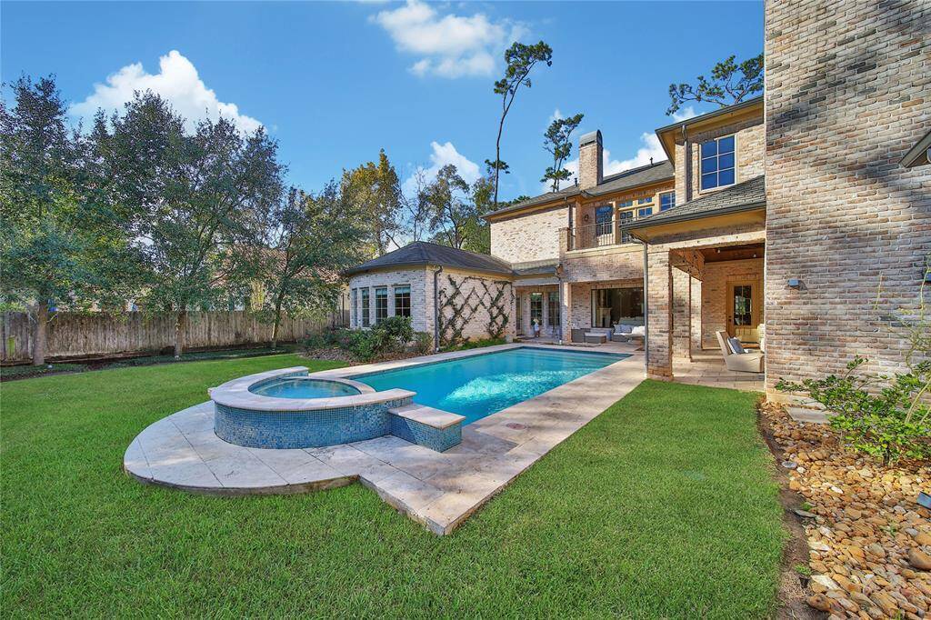 Stunning backyard featuring a pool and spa, a covered patio, and a fully-equipped outdoor kitchen.