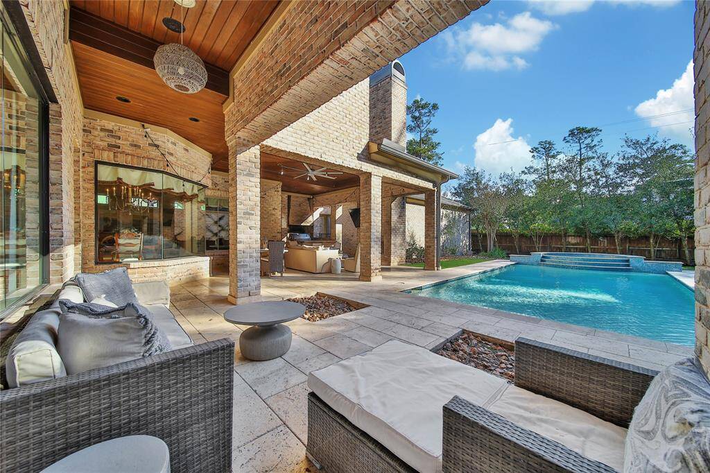 Stunning backyard featuring a pool and spa, a covered patio, and a fully-equipped outdoor kitchen.