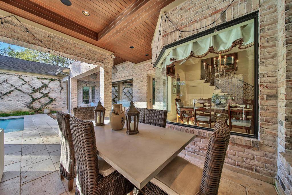 Stunning backyard featuring a pool and spa, a covered patio, and a fully-equipped outdoor kitchen.