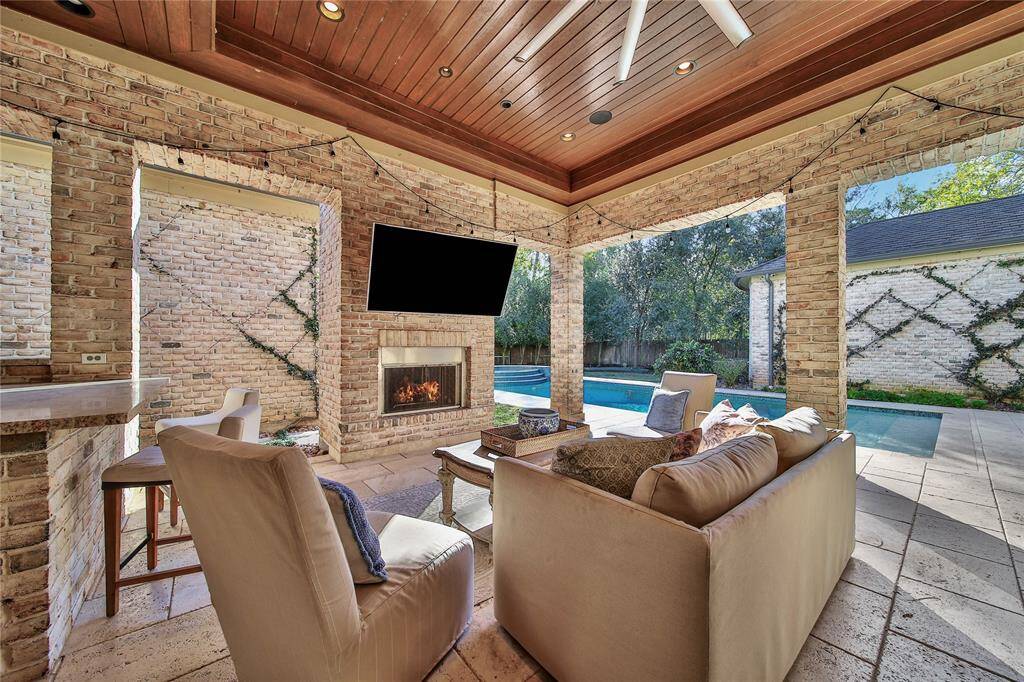 Stunning backyard featuring a pool and spa, a covered patio, and a fully-equipped outdoor kitchen.