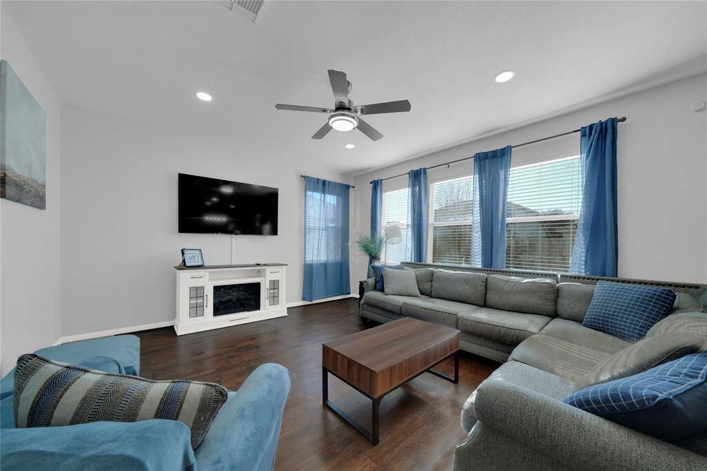 Looking into the living room, you are greeted by ample amount of natural lighting.
