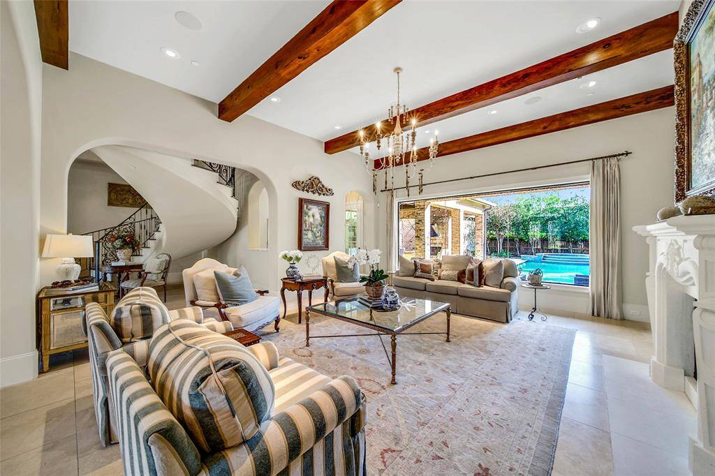 Formal living room with backyard views and gas fireplace.