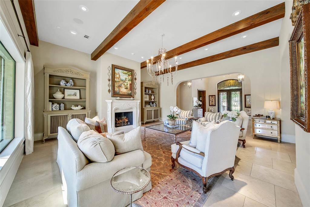 Formal living room with backyard views and gas fireplace.