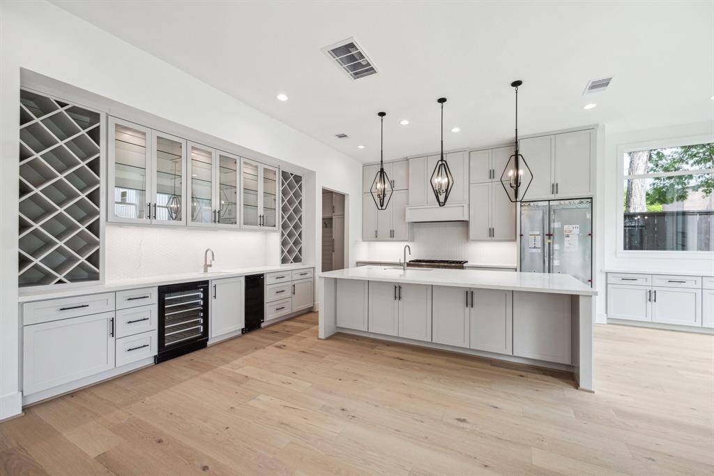 Fantastic Wet-Bar with Sink, Wine Chiller and Ice Maker.  There is all Wine Storage, Storage Drawers, Upper Cabinets with Glass Fronts and more.... Construction as of April 18th, 2025.