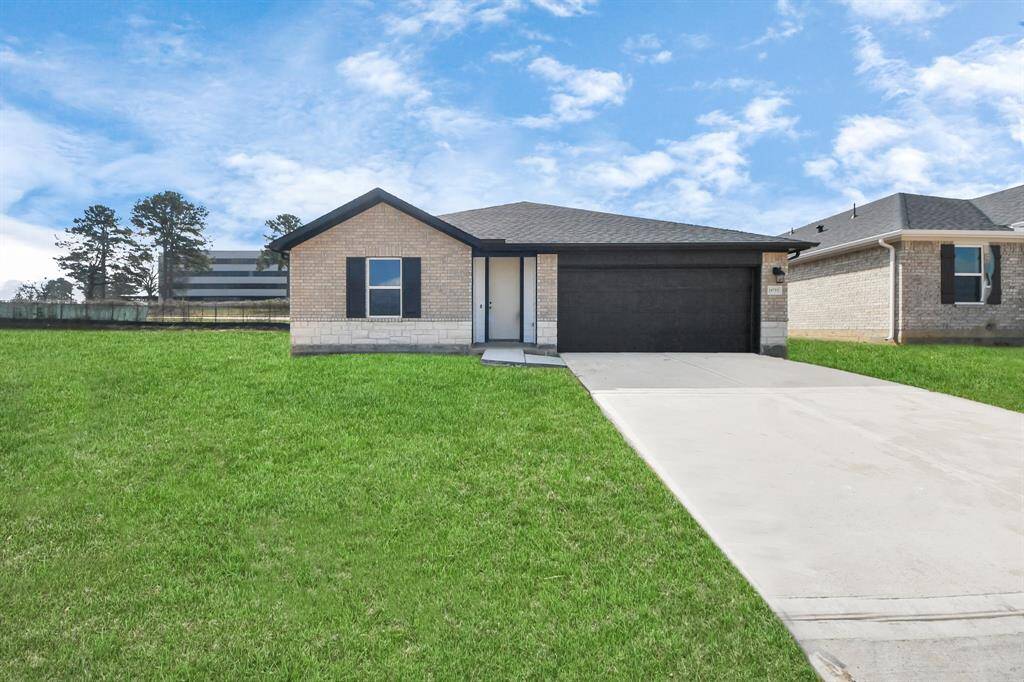 Actual exterior of home, construction - 90% complete. Glass front door, landscaping and perimeter fence pending installation.