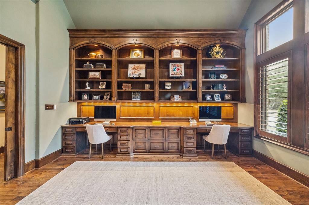 Located just off the gallery from the formal entry, solid wood pocket doors reveal the dedicated, private library with two custom built-in desks, drawers, display shelving and task lighting. A generously sized powder bath is just steps away.