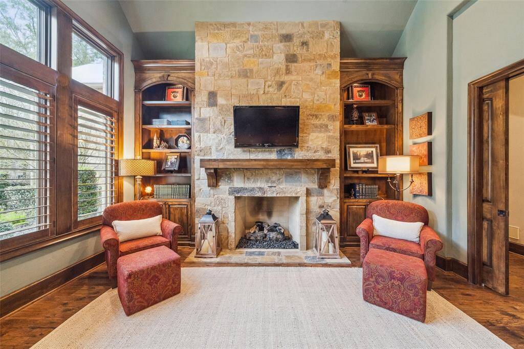 This handsome study exudes warmth and sophistication. Oversized windows illuminate the library with natural light and provide a view of the front of the estate. Bookcases flank the gas log fireplace creating a cozy place to read a book on a chilly evening.