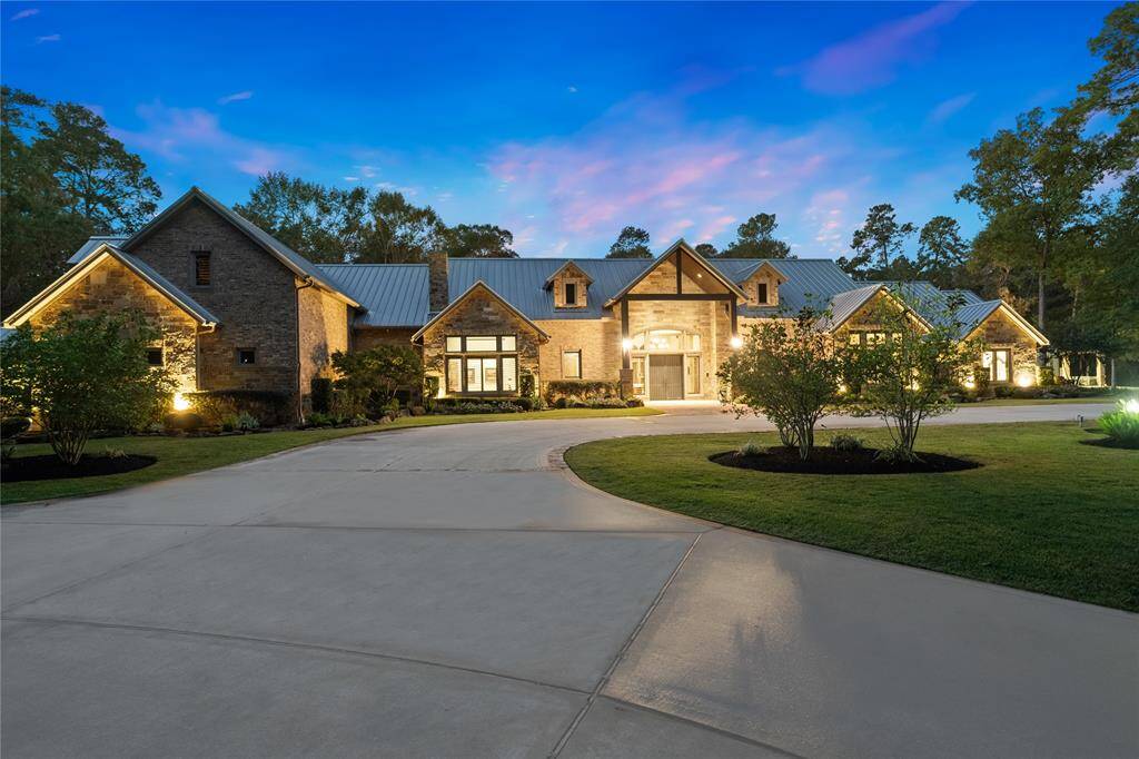 The stone and brick exterior is accented with cedar posts and beams and is nestled among the soaring trees and Texas landscape. The metal standing seam roofing system is both durable and architecturally pleasing. Access to the home is protected by a motorized gate leading to a circular driveway in front of the house, two vehicle porte-cochere and four car oversized garage discreetly hidden from view.