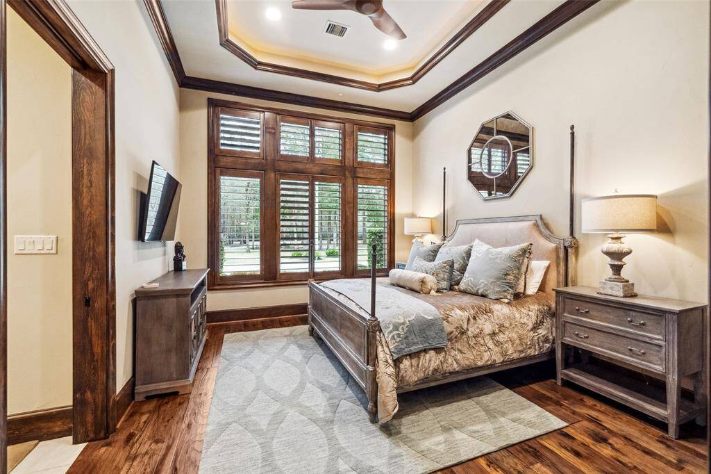 All secondary bedrooms are spacious and private and located on the main level on the opposite wing of the home from the Primary Suite. Three of them easily accommodate a king size bed and feature walk-in closets and en-suite bathrooms. This bedroom overlooks the front circular drive and grounds.