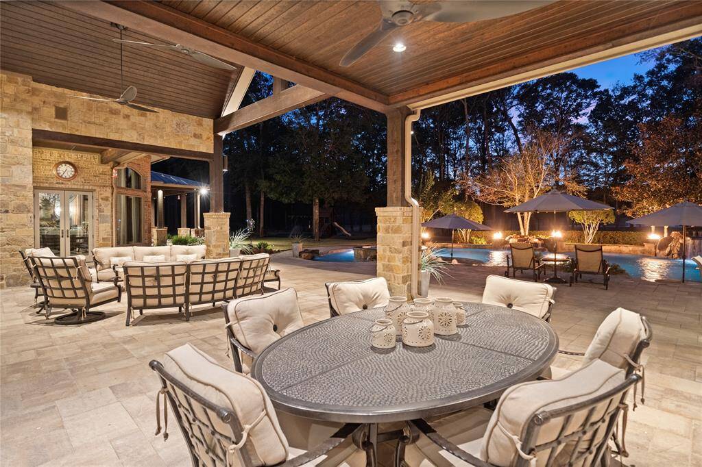 The outdoor living space extends the square footage of this estate further and functions like a private resort. The large outdoor living, dining and kitchen areas are finished with tongue and groove ceilings and feature a wood-burning fireplace, storage closet, pool bath and outdoor shower.