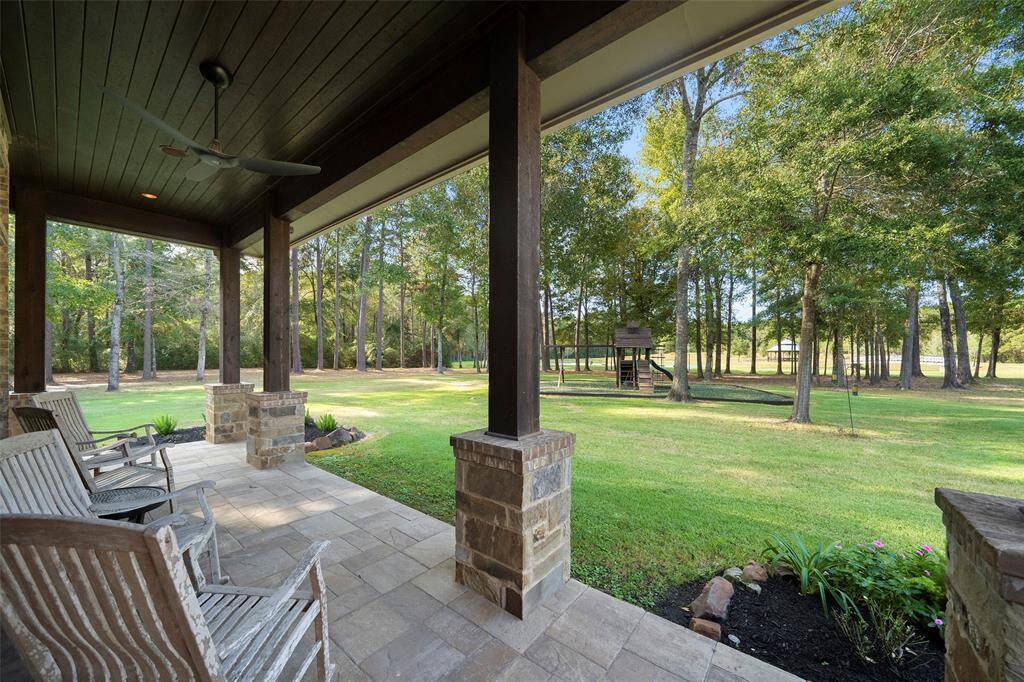 Accessed privately from the primary bedroom, this wrap-around, well-shaded patio is the perfect place to enjoy your morning coffee or watch little ones at play in their own private playground with slides, swings, rock climbing wall and fort!