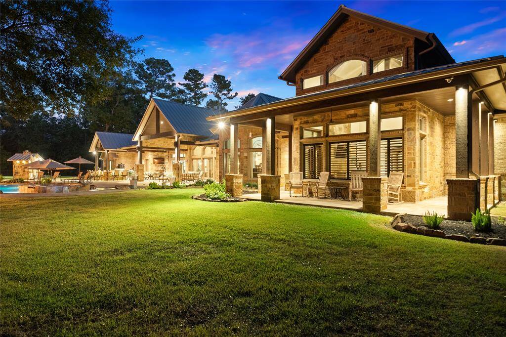 The rear elevation of this custom estate is as inviting as the front. With multiple entertaining areas and the resort style pool, the possibilities are endless. A well provides nourishment for the lawn and multiple flowerbeds, powered by a Baseline Irrigation System located in the barn and operated from your smartphone. If desired, the main house can also access the well water with the simple turn of a valve.