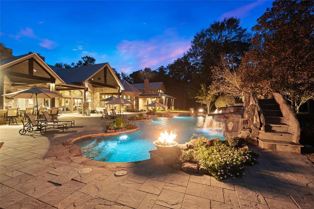The 14' waterfall slide ensures hours of fun for kids and adults alike. The rock waterfall and cove add a distinctive look to this pool as well as a tranquil ambience provided by the relaxing sound of moving water. The pool features a propane Heater and Geo-Thermal Heater, Paramount In-Floor cleaning system, automated controls and a custom whole-pool leaf cover.