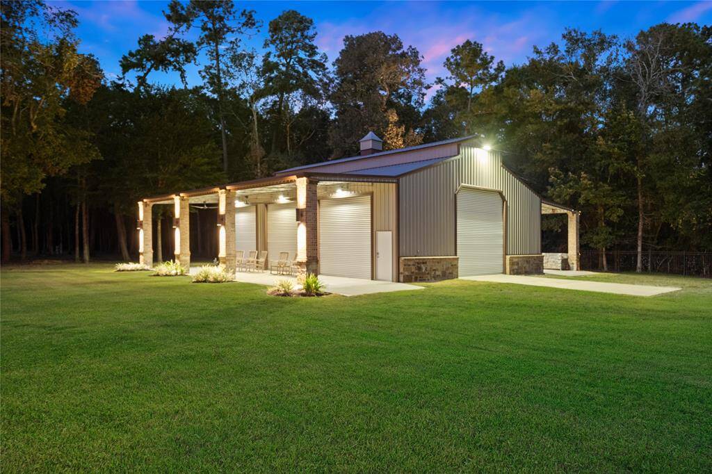 This 50'x40' Hawthorne Steel Buildings barn tastefully trimmed with stone can house a 45' RV and is insulated, guttered and plumbed. It features two large overhead doors and 3 overhead doors on the West side and 3 horse Dutch doors on the East side, all under covered leans. It is also protected with a security system. The barn is thoughtfully topped with a weathervane!