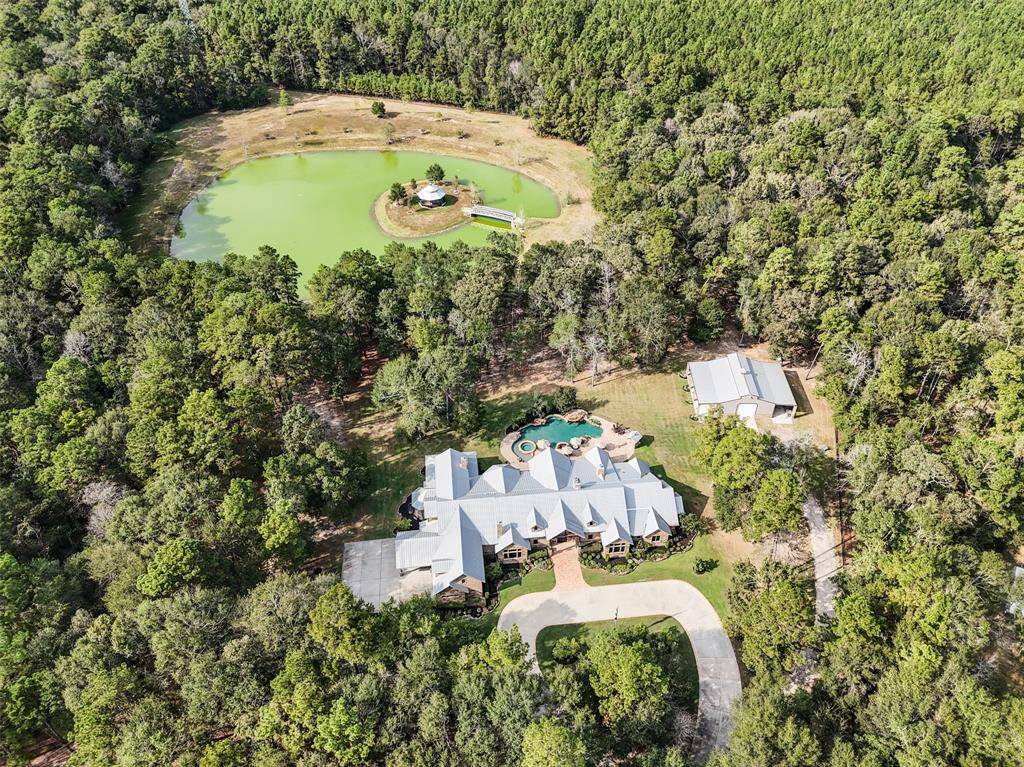 This exquisite property features 10 wooded acres, a 3 acre pond with 3 acres cleared land surrounding it, an almost 9,000 square foot home constructed in 2014, a gazebo, barn, playground and 50,000 gallon pool!