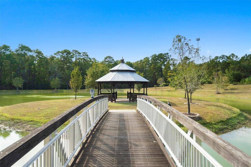 Ascend to the island gazebo along this 50' arched bridge, made of welded aluminum and Ipe hardwood decking and rails.