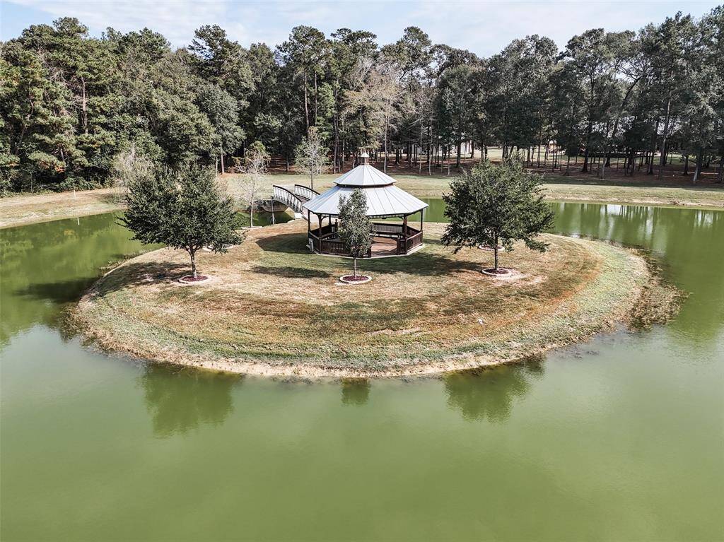 6 acres of this 24.5 acre estate were cleared to make space for this 3 acre pond, stocked with Black Bass and Blue Catfish, an automatic fish feeder and underwater Aeration system with 4 fountains. The island is topped with a 30' octagonal gazebo illuminated with LED lighting.