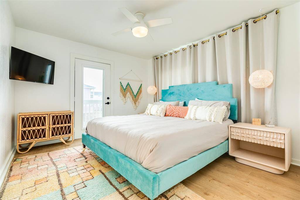 Spacious bedroom featuring modern decor, a cozy bed, natural light, and a private balcony access for ultimate relaxation.