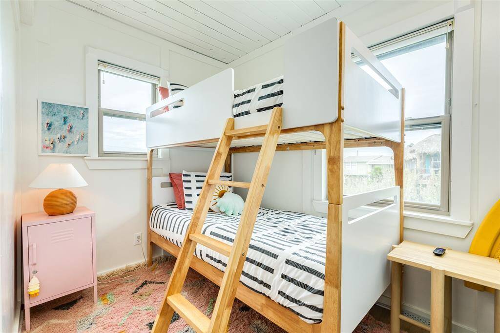 Bright and airy bedroom featuring cozy bunk beds, perfect for maximizing space and comfort.