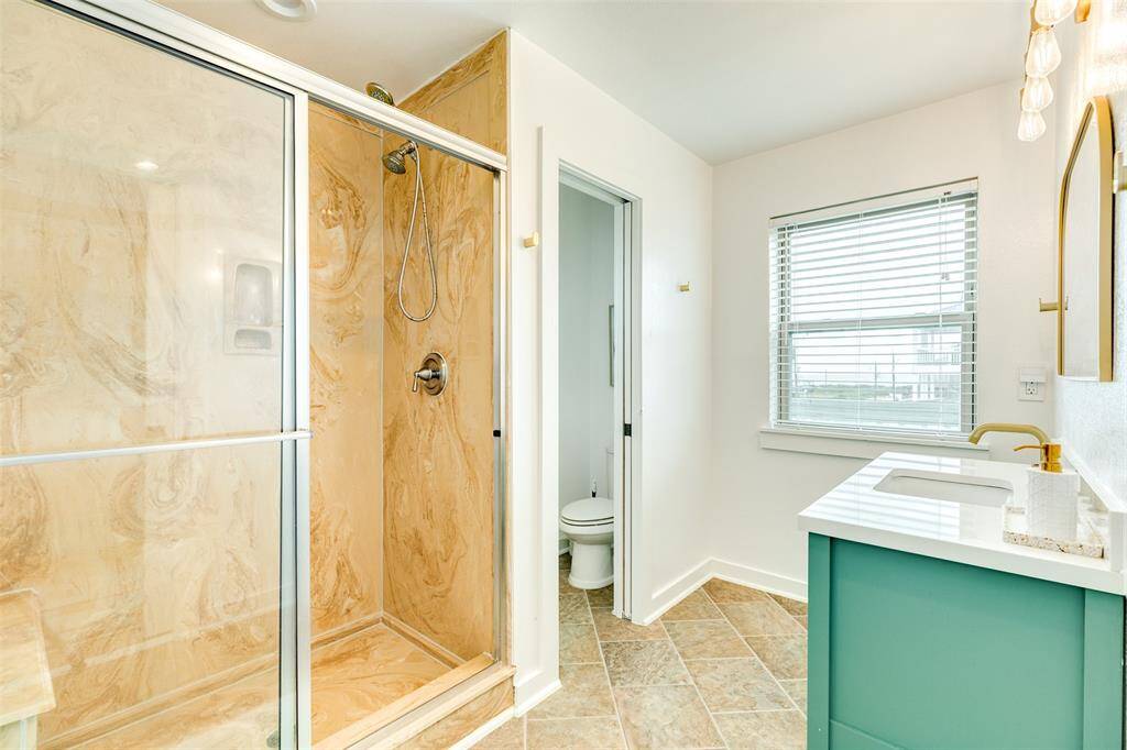 Luxurious walk-in shower with elegant marble finish.