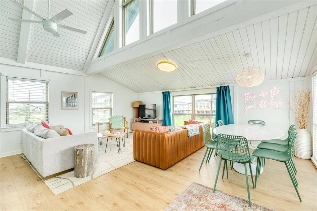 Bright and airy living space featuring high ceilings with stylish fans, perfect for relaxation and entertaining.