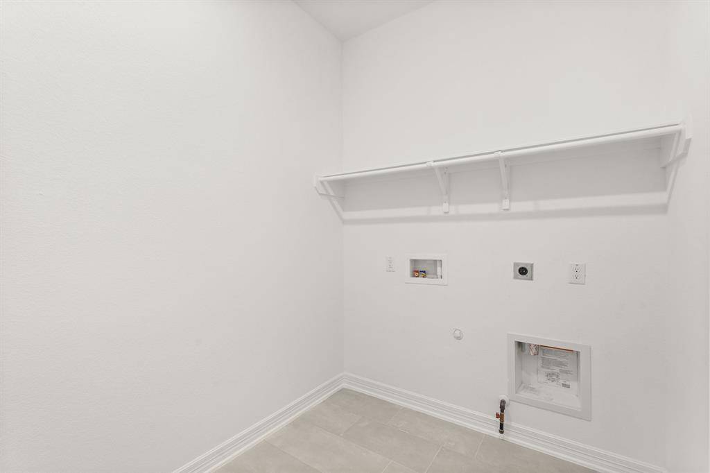 The laundry room layout is carefully planned for optimal workflow with designated areas for washing, drying, and storing.