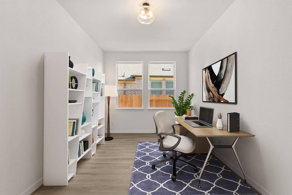 The home office features French doors, beautiful floors, large windows that give a fresh feel, this space promotes focus and creativity. Photo is virtually staged