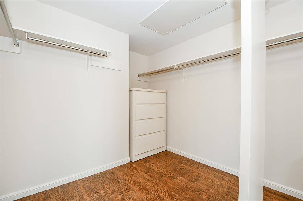 Oversized primary closet with built in storage/chest
