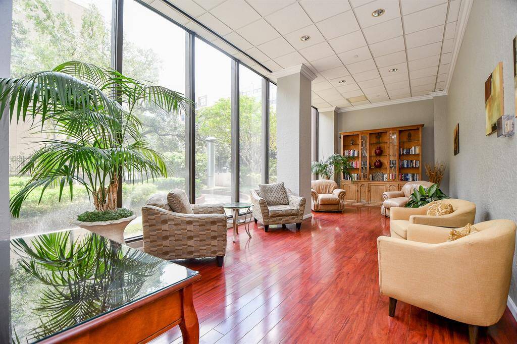 Informal gathering room/library overlooking the lush rear courtyard