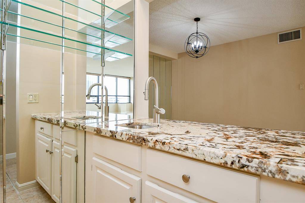 Wet bar with granite counter tops and storage
