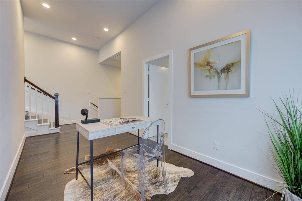 An inviting home office space with ample natural light, stylish decor, and a clear desk for productivity. This space is perfect for remote work or study, ensuring a comfortable and inspiring environment.