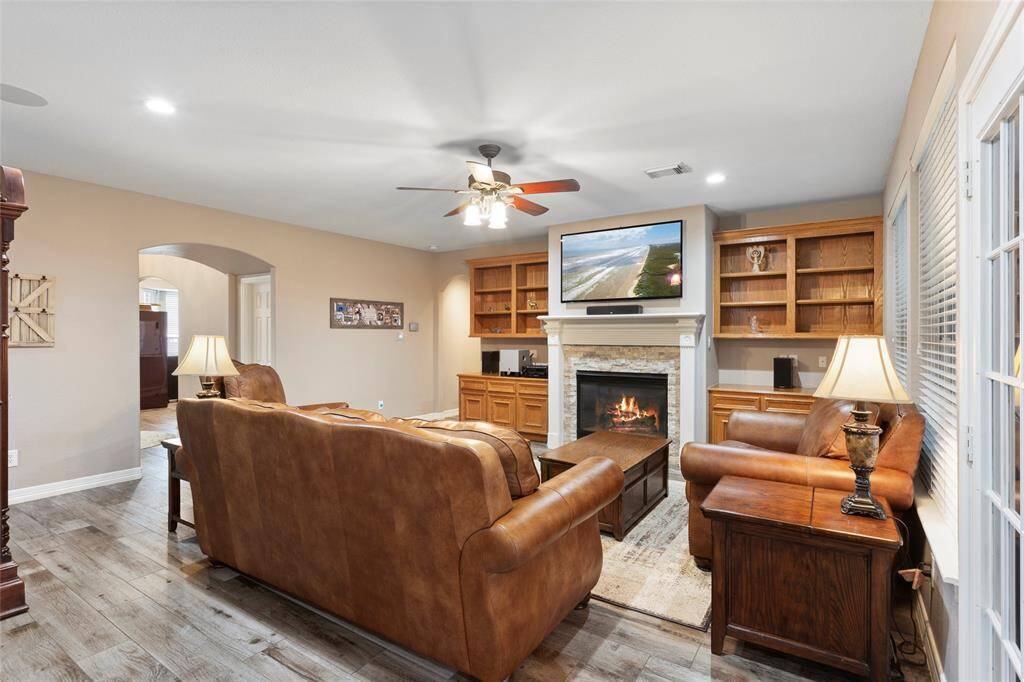 Solid wood built in cabinets surround the stacked stone fireplace.