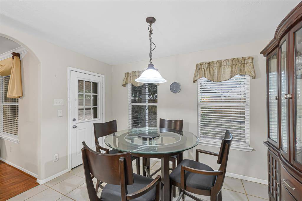 The breakfast area off of the kitchenserves as a perfect spot for familybreakfasts, casual dining, or enjoyinga morning coffee while overlookingthe backyard. Features includeneutral tile floors, a lighting fixture, and an abundance of windows that flood the space with natural light.