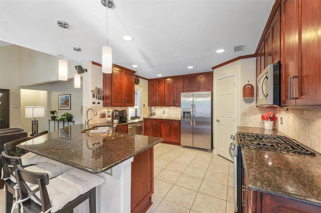 Another view of this great kitchen with plenty of cabinets, counters and a pantry.