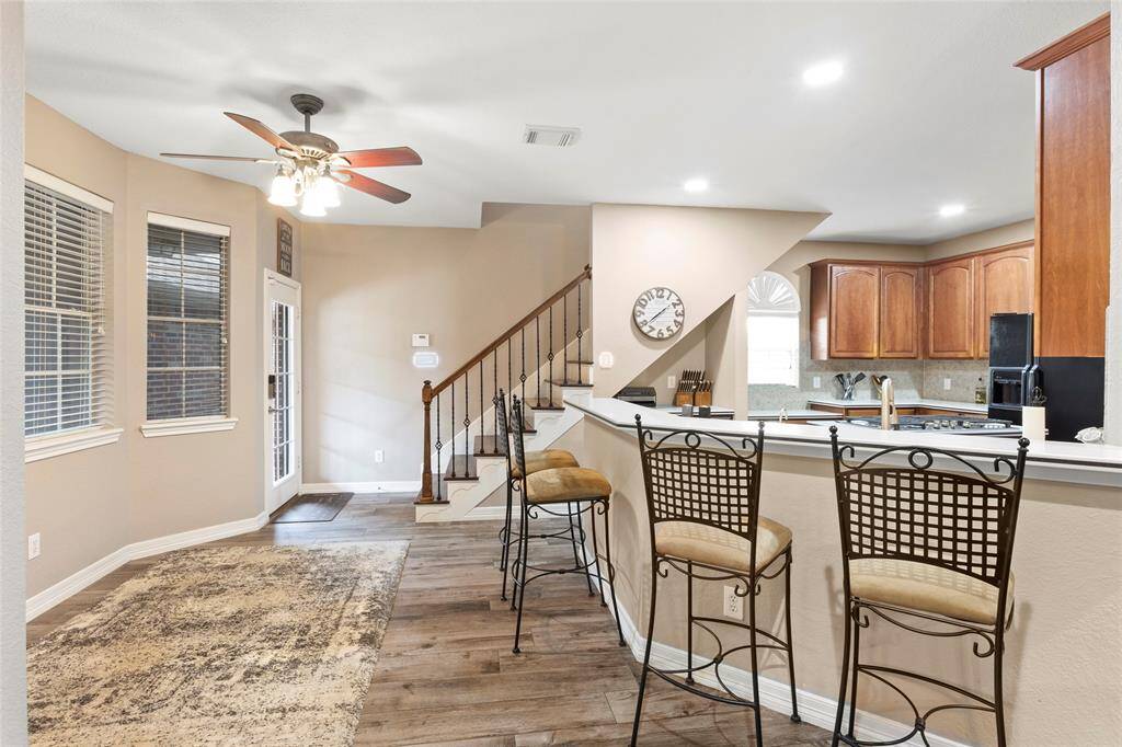 Breakfast area plus large breakfast bar overlooking kitchen with a peek at the back staircase.