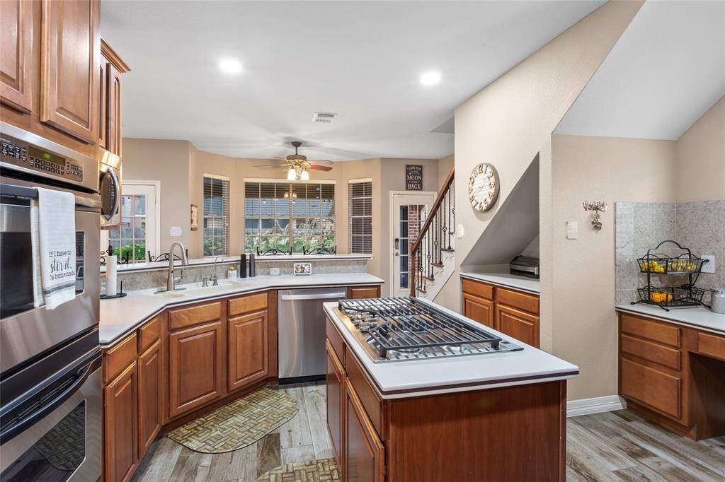 Stainless steel appliances include a double oven, 5 burner cooktop and new 2024 dishwasher.