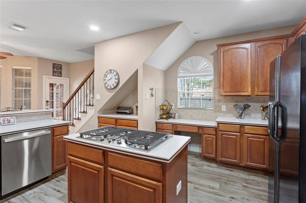 Lots of cabinets for storage plus a built in desk area overlooking the side yard.