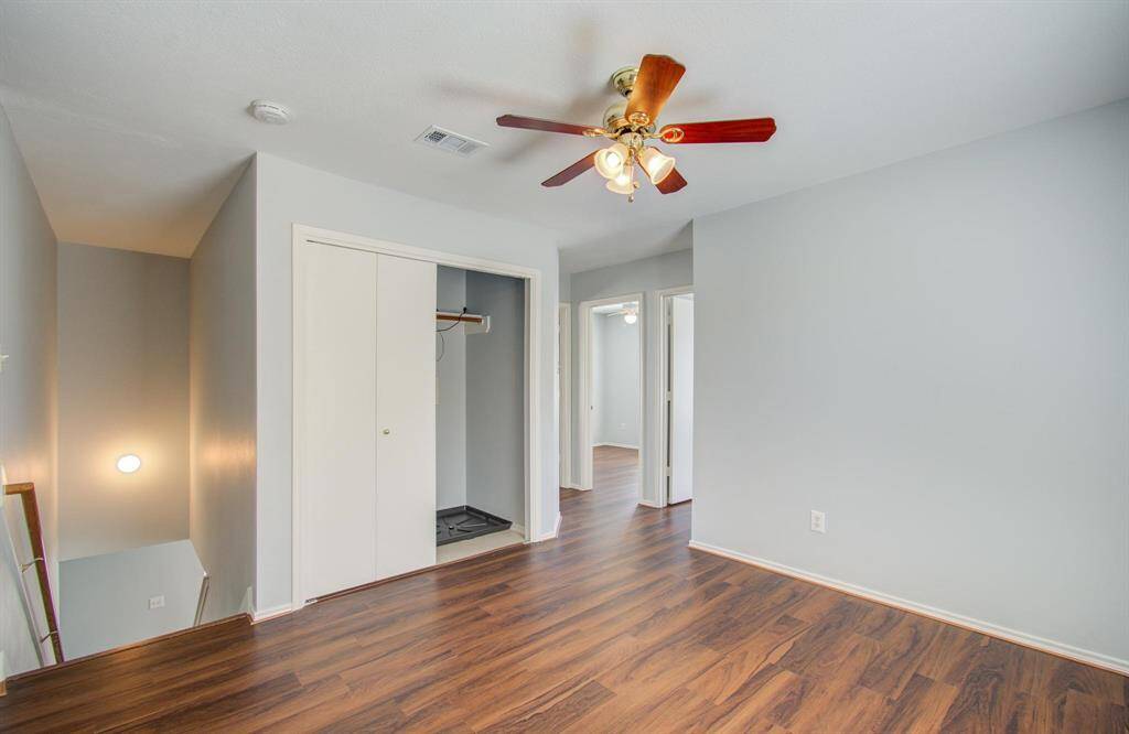 Game room features vinyl flooring, a ceiling fan, and a closet with sliding doors. It has an adjoining hallway leading to the bedrooms.