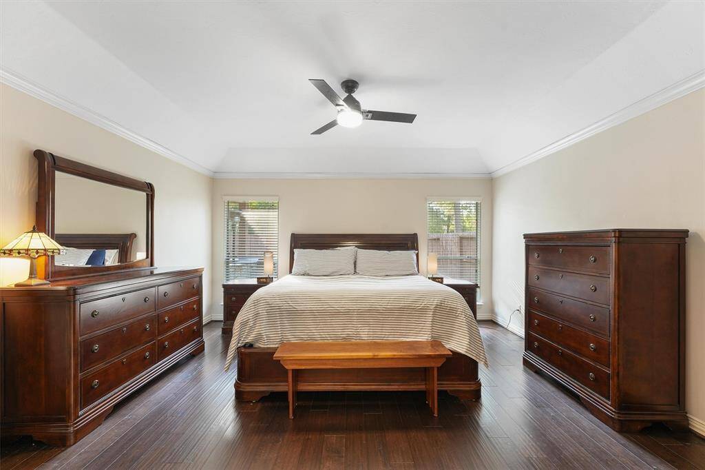 The large  first floor primary bedroom has  hardwood floors and an ensuite bath.