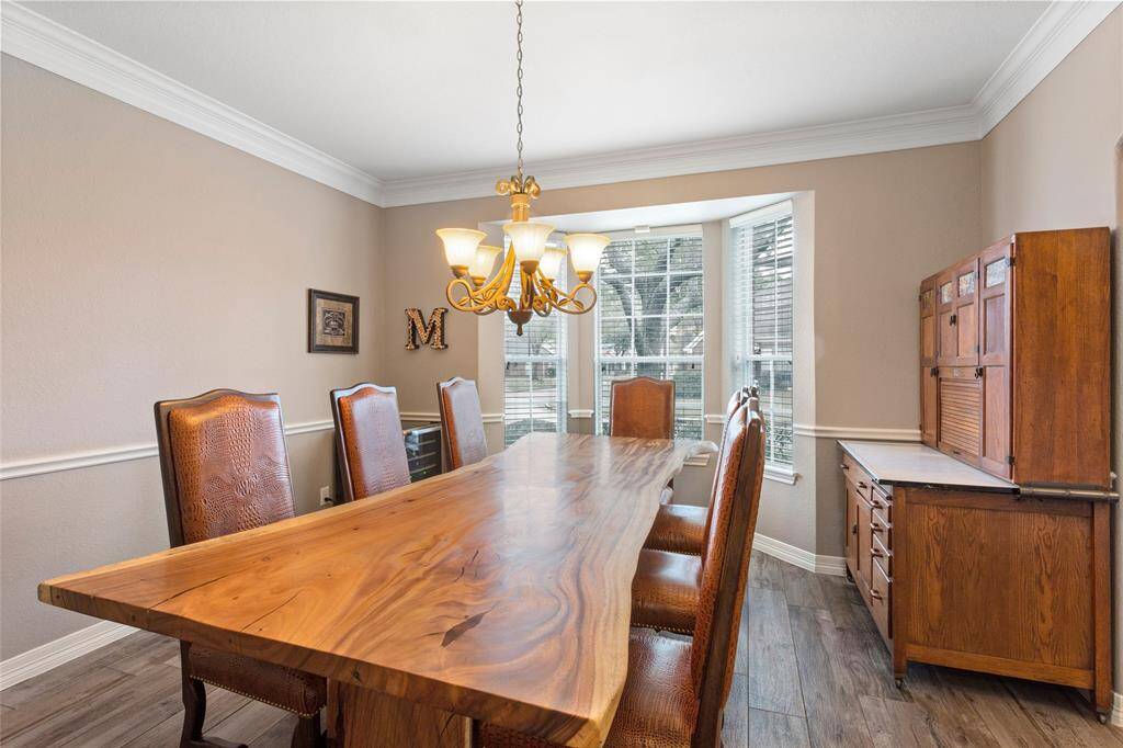 Formal dining room with bay window and double crown molding.