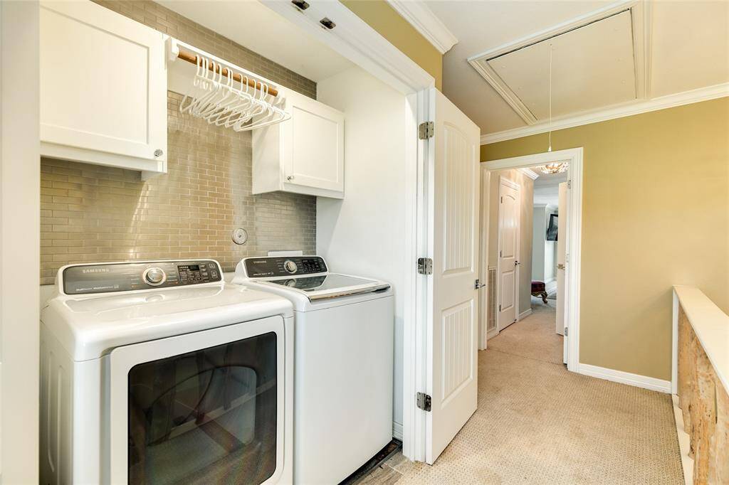 Utility closet upstairs has built-in cabinets & a drying rod. Original attic access door was replaced with an oversized one for easier access