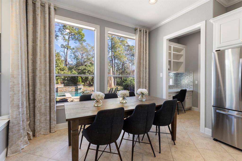 Enjoy family meals in the bright, inviting kitchen while looking out at the gorgeous backyard, creating a seamless connection between indoor and outdoor living. The view enhances the space, offering a tranquil setting for everyday dining and gatherings.
