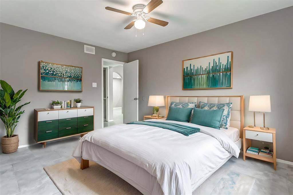 Another view of the bedroom reveals its functional layout with plenty of space for furniture and storage. The clean lines and soft color palette create a calming atmosphere, ideal for unwinding at the end of the day.